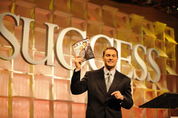 Darren Hardy holding Success Magazine on stage