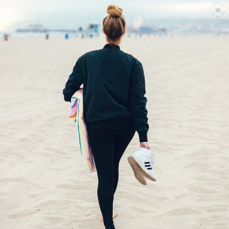 girl walking on the beach after implementing a couple of these online jobs for college students