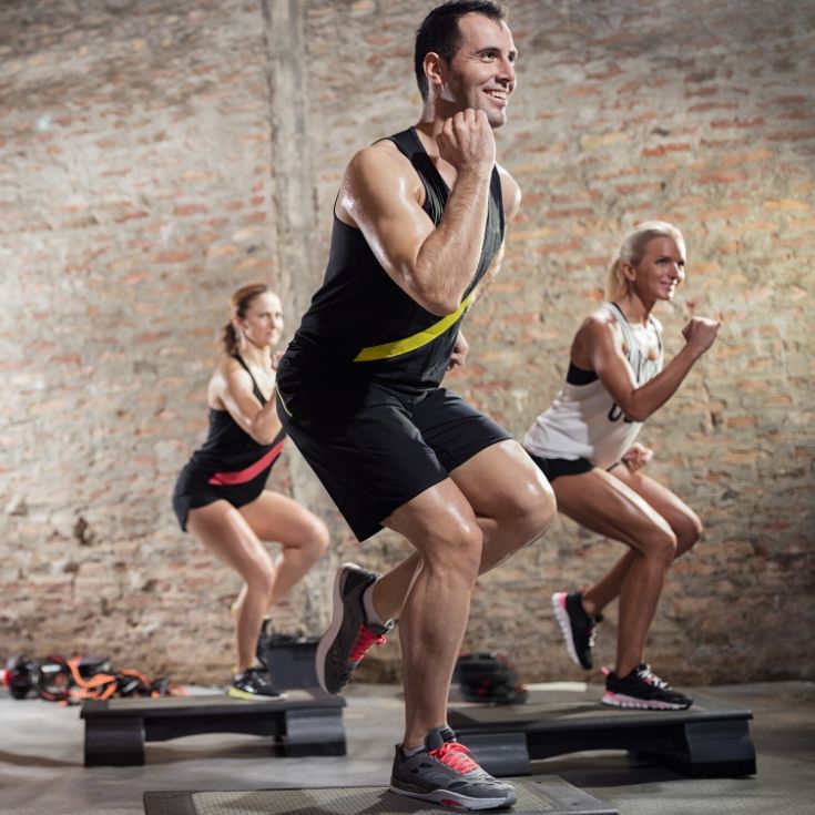 A man and 2 women doing a BODYSTEP workout