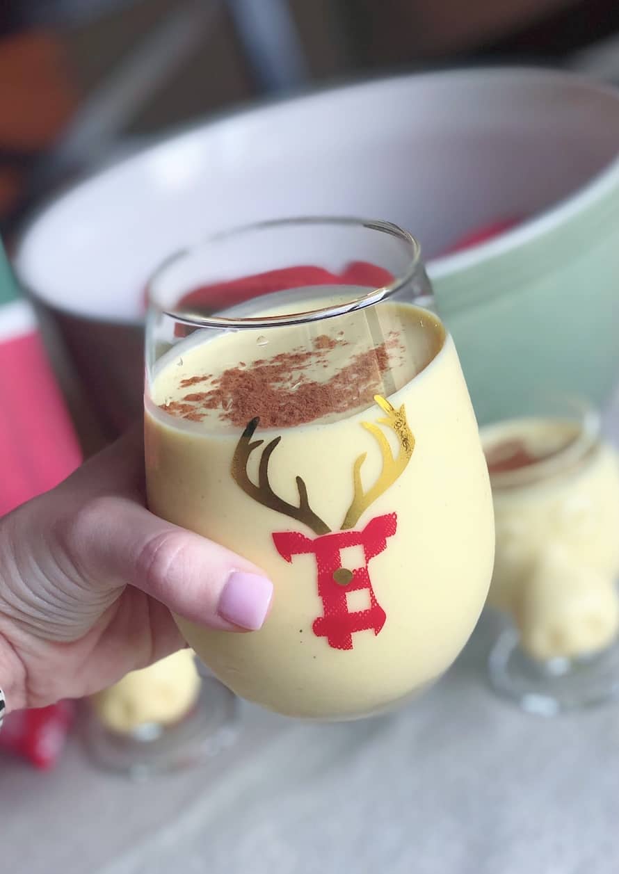 holding a glass of eggnog