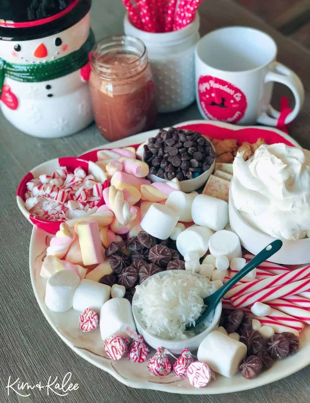 How to Make a Hot Chocolate Charcuterie Board with a snowman, mugs, and straws