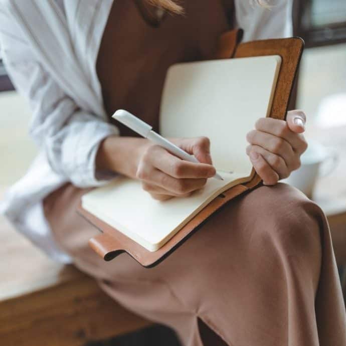 woman writing in a journal