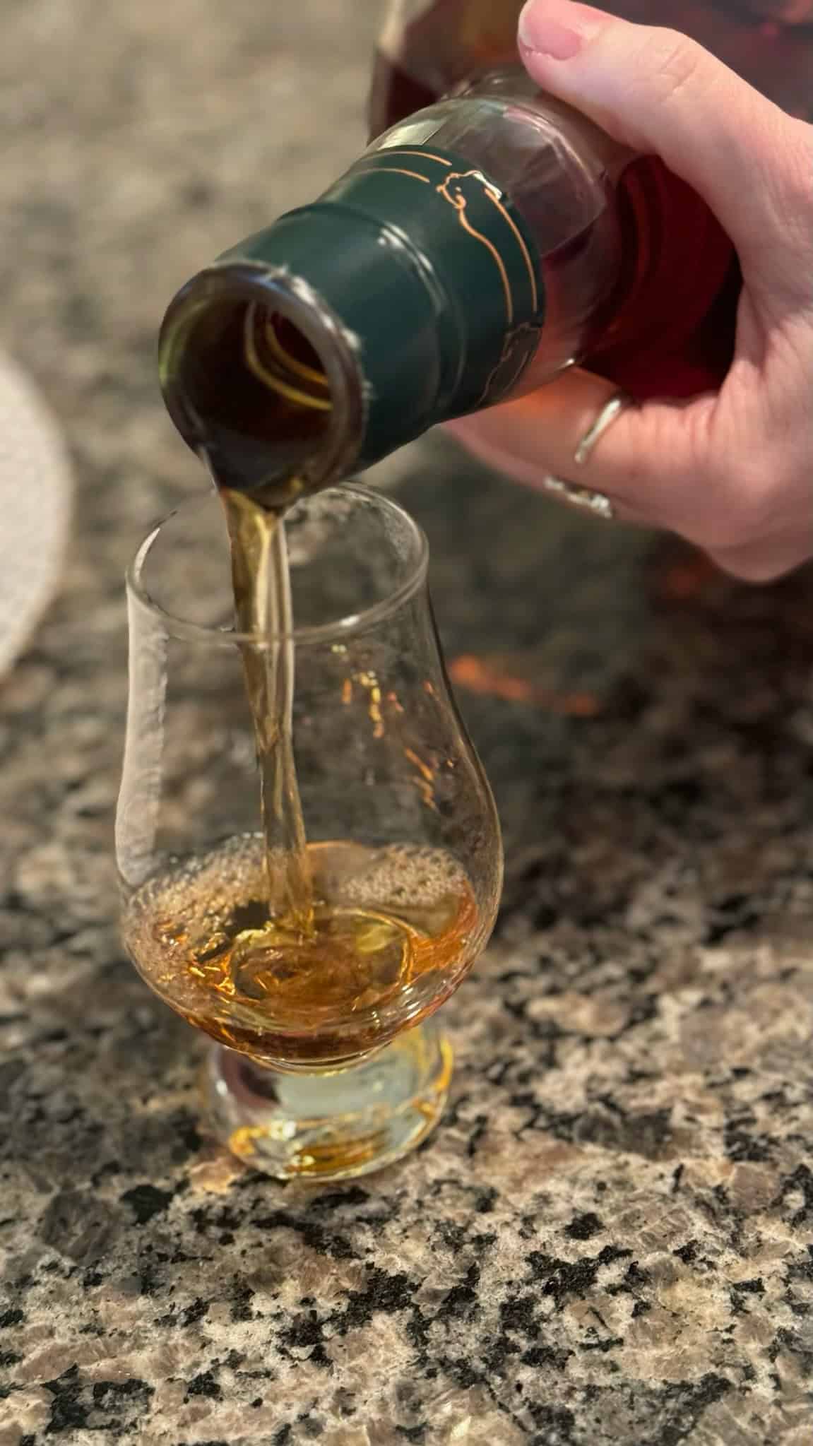 pouring into a bourbon glass