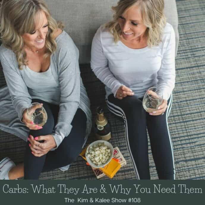 Kim & Kalee sitting on floor with candy & bubbly