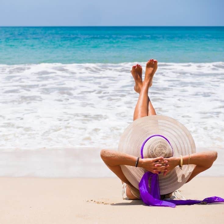 woman relaxing on the beach repeating affirmations for confidence