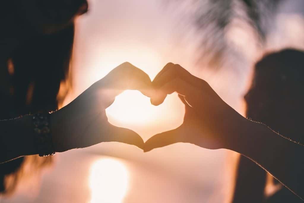 best friends making the heart shape with hands