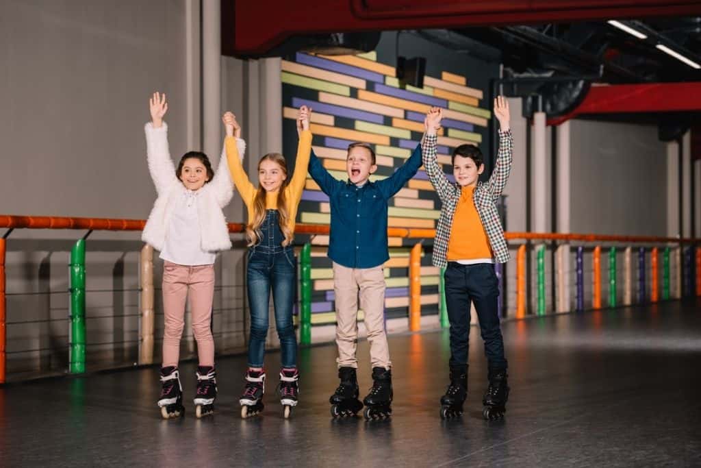 kids at a skating rink for a 10th birthday party idea