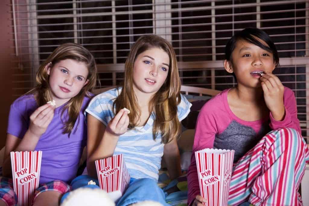 3 tweens watching a movie