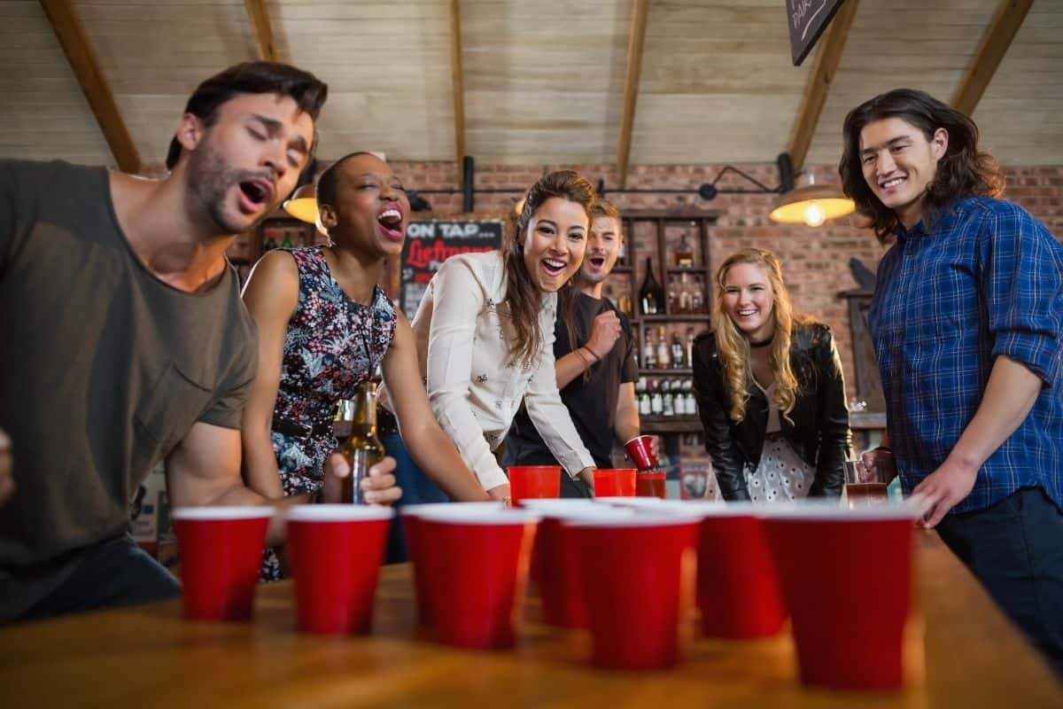 drinking game - people playing beer pong