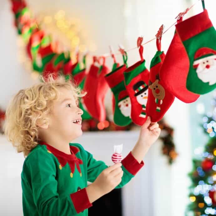 little boy reaching for a small bag on an advent calendar