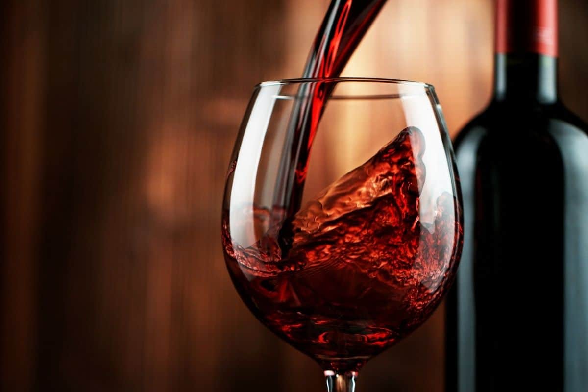 red wine being poured into a wine glass