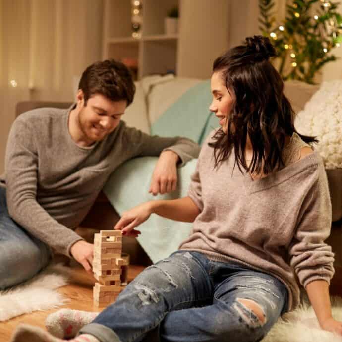 couple playing jenga at home