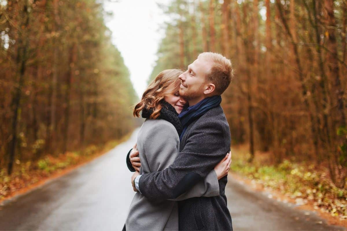 happy couple hugging outside in the fall