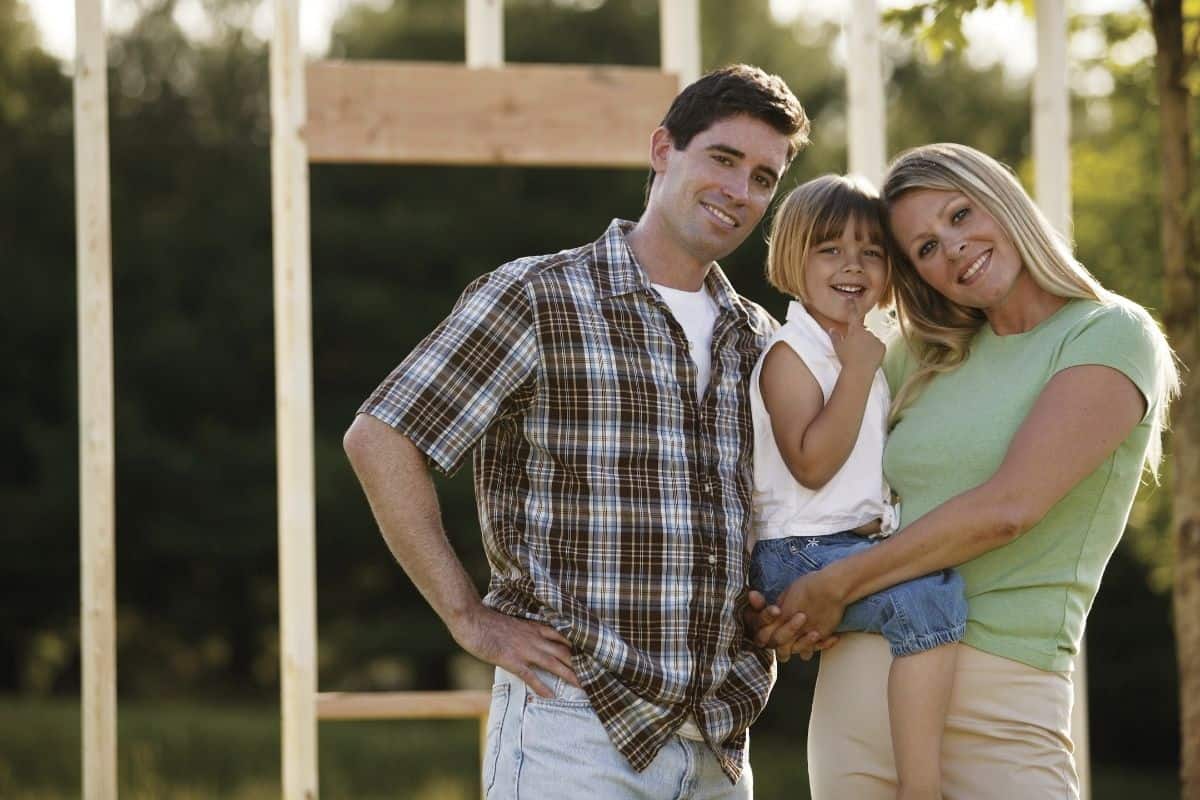 family by a new home construction