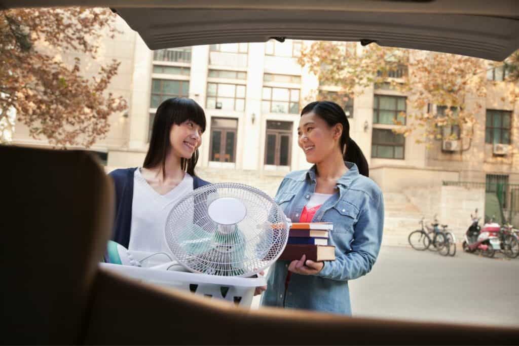 mom and daughter at the car moving into college