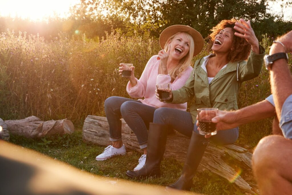 2 women laughing and having fun camping