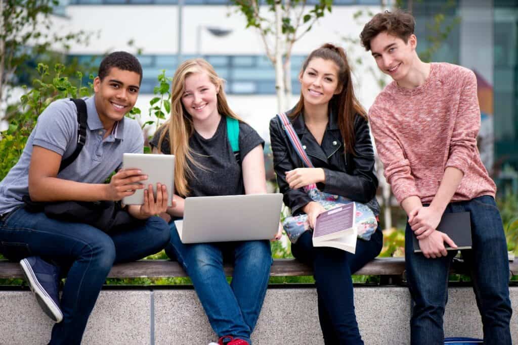 group of 4 college kids on campus