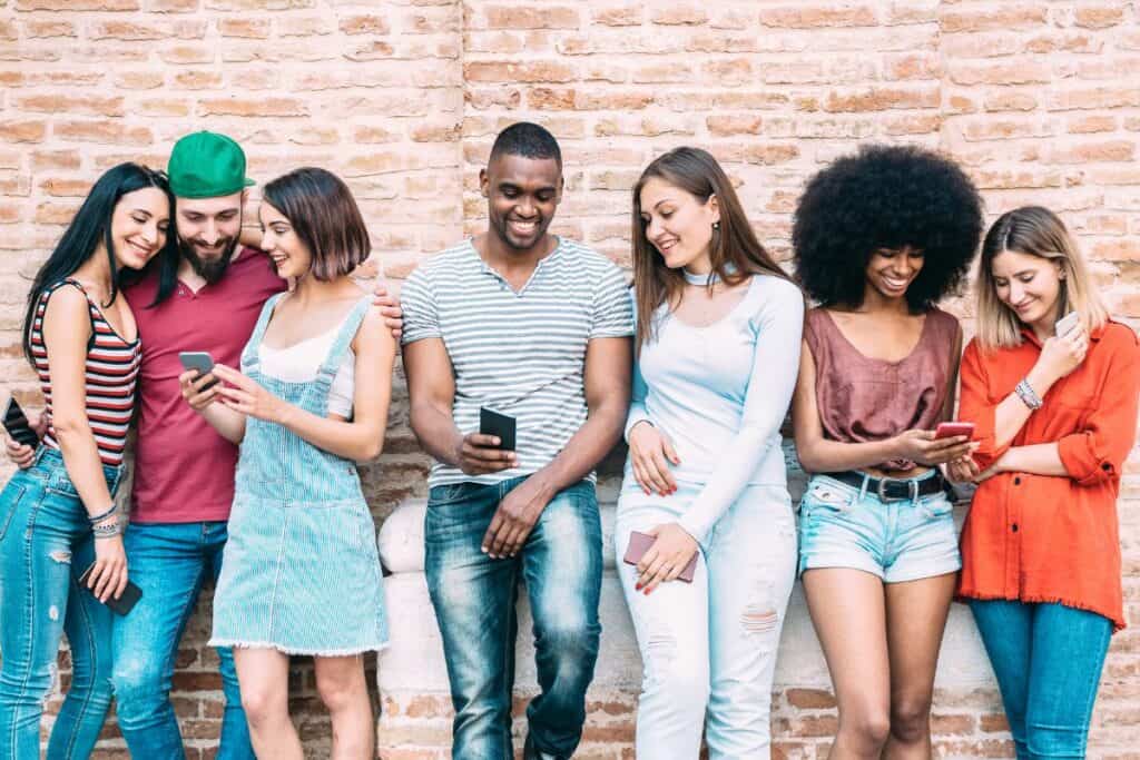 group of college kids looking at their phones