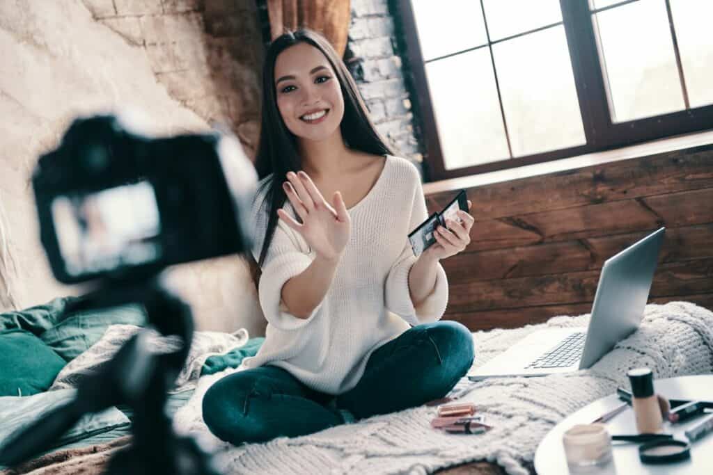 college age girl recording a youtube video