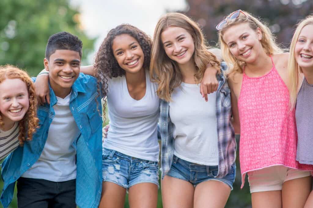 group of teens outside in the summer