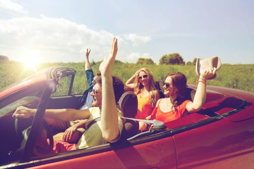 teens in a convertible car