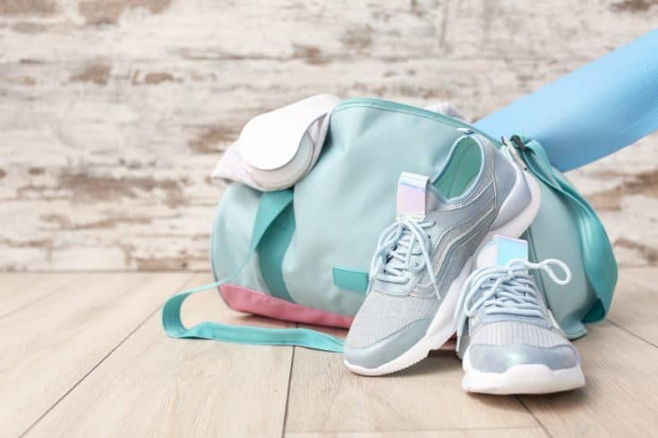 pair of tennis shoes, a gym bag, yoga mat, and headphones