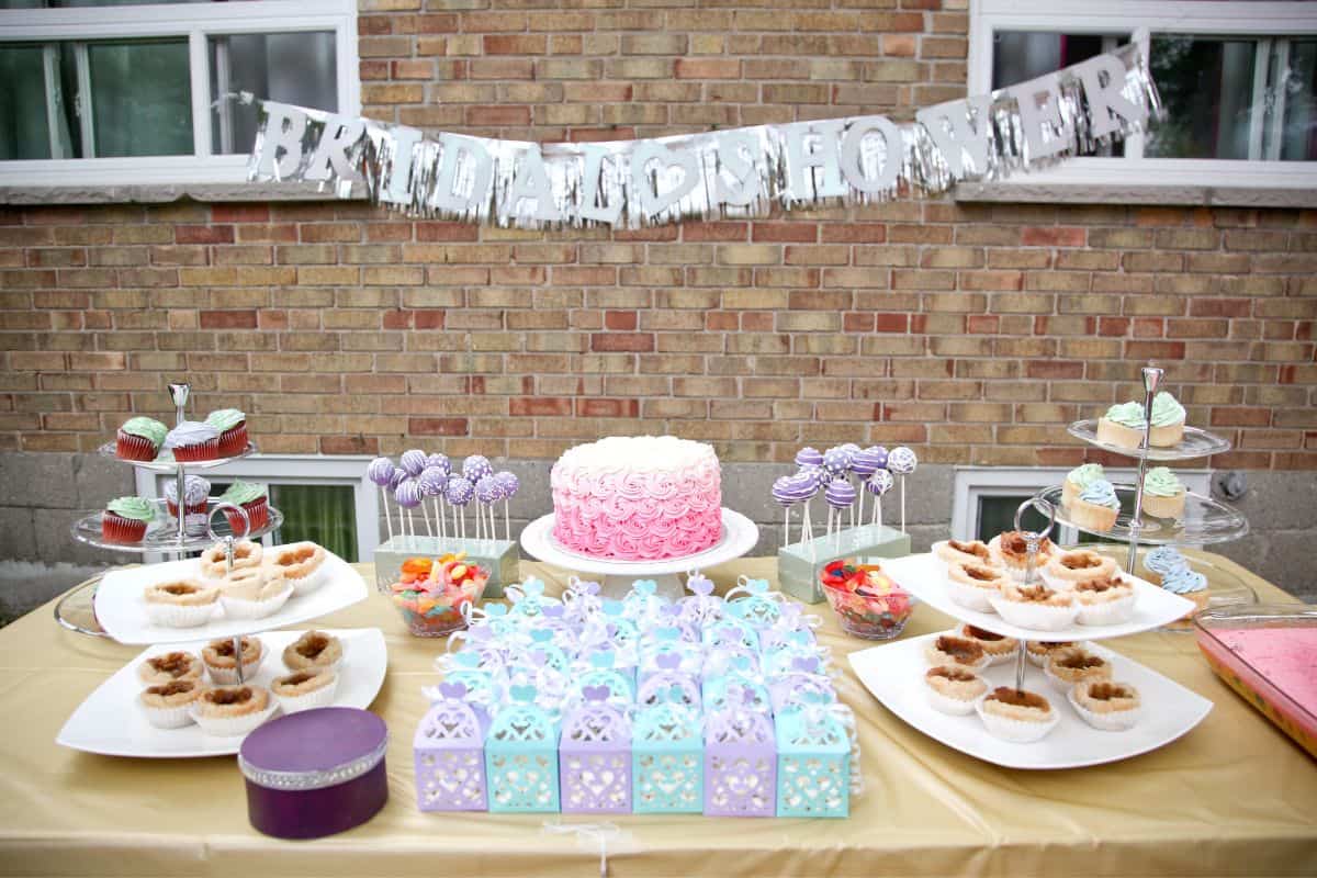 a bridal shower dessert table set up outside