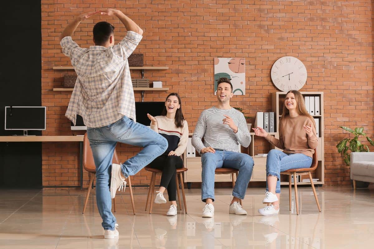 4 friends doing dance charades