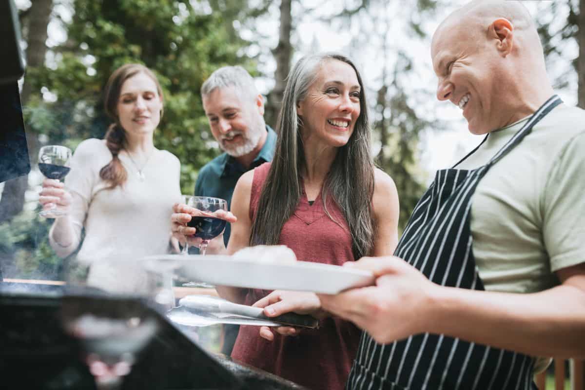 friends in their 60s at an outdoor bbq