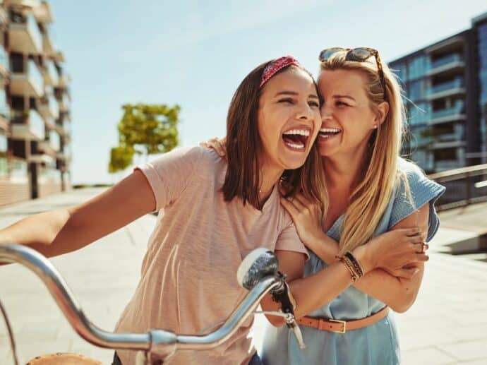 2 female best friends outside laughing