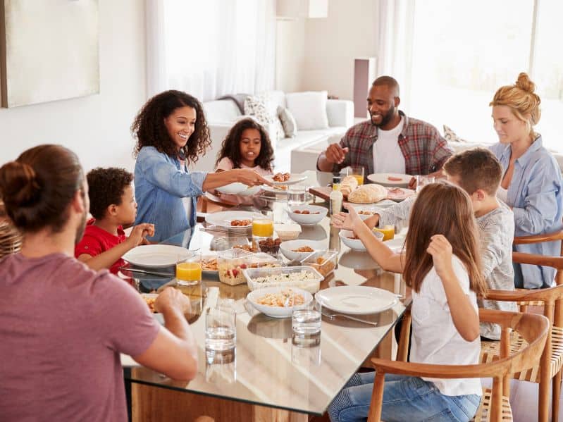 family on a beach vacation eating dinner