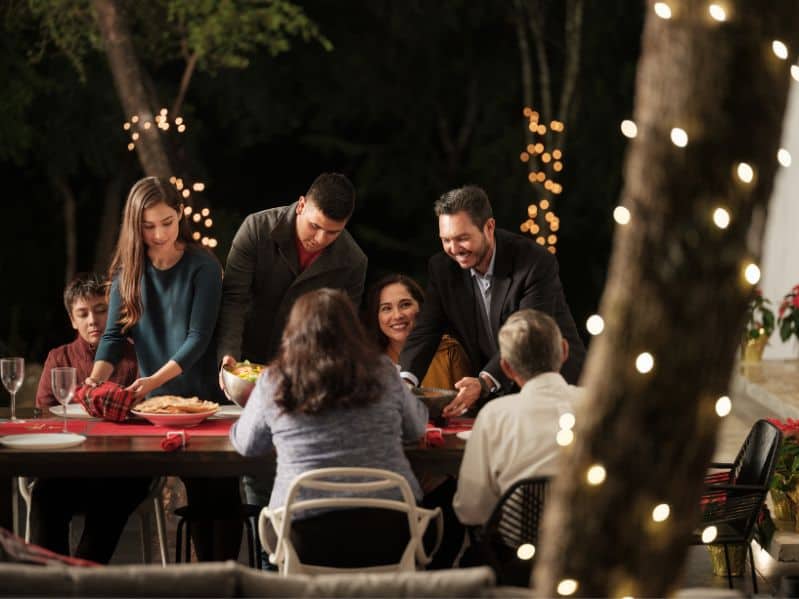 family at a backyard anniversary party idea at night