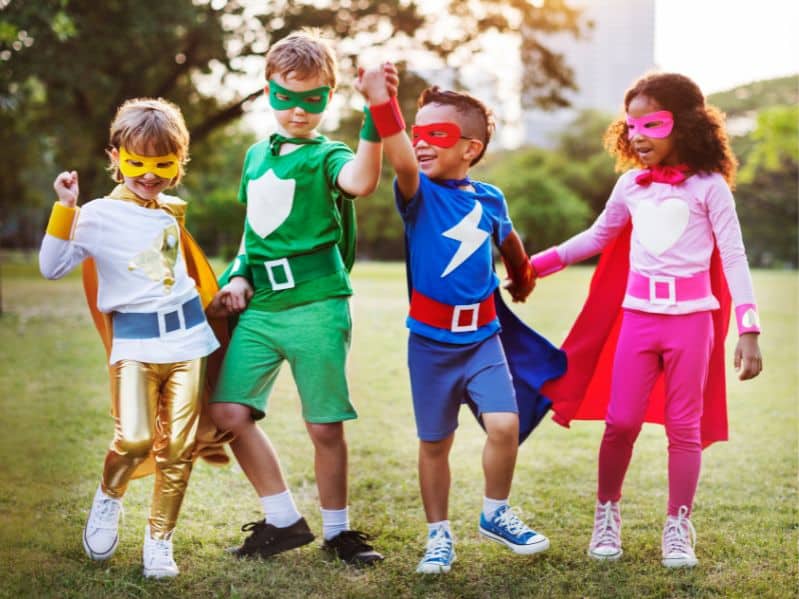 kids dressed as super heroes outside