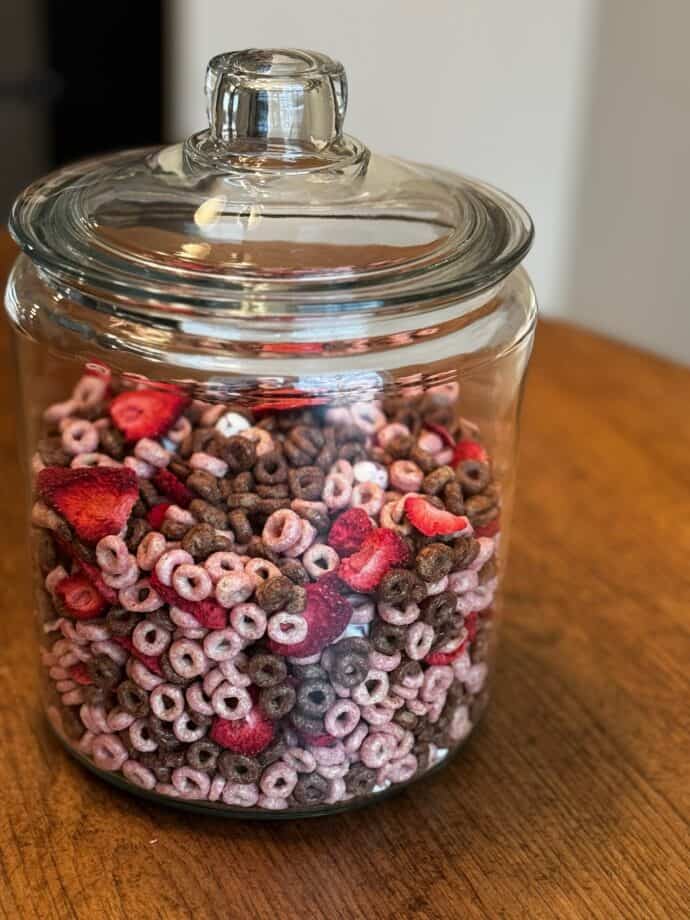 glass jar holding the strawberry snack mix