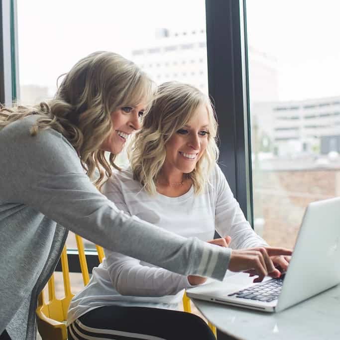 kim and kalee looking at laptop computer